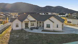 View of front of house featuring board and batten siding, stone siding, a porch, and a residential view