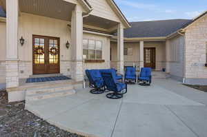 Entrance to property featuring french doors, a shingled roof, and board and batten siding