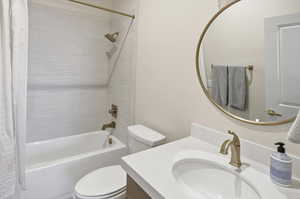 Full bath featuring shower / tub combo and vanity