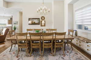 Dining room featuring a chandelier, light wood finished floors, and recessed lighting