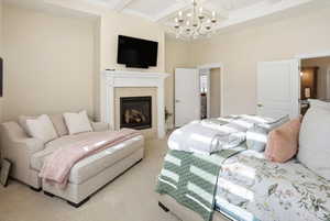 Bedroom featuring carpet flooring, beamed ceiling, coffered ceiling, a fireplace, and a towering ceiling