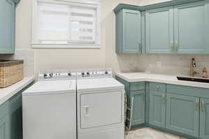 Laundry room featuring cabinet space and washing machine and dryer