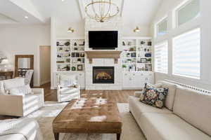 Living room featuring a stone fireplace, wood finished floors, recessed lighting, wood ceiling, and radiator heating unit