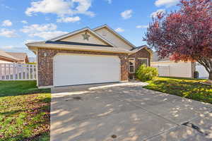 View of front of house featuring a shingled roof, brick siding, concrete driveway, and an attached garage