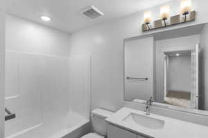 Full bath with shower / bath combination, vanity, and recessed lighting