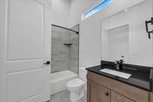 Full bath featuring shower / tub combination, vanity, and light tile patterned floors