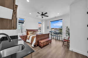 Bedroom featuring light wood finished floors, recessed lighting, and ceiling fan
