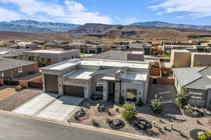 View of front of house with a residential view, stucco siding, concrete driveway, and a garage