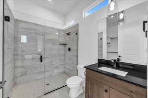 Bathroom featuring a stall shower, vanity, and light tile patterned floors