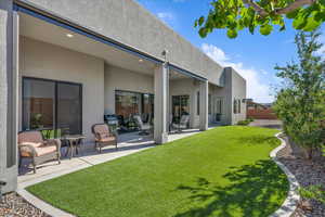 Back of house with stucco siding and a patio area