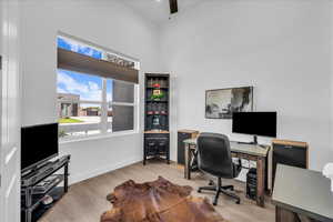 Office area featuring light wood-style flooring and a ceiling fan