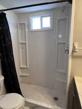 Full bath featuring a shower stall, vanity, and light tile patterned floors
