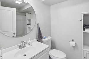 Bathroom with vanity, curtained shower, and a textured wall