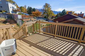Wooden deck featuring a southeast mountain view, a fenced backyard, and stairs