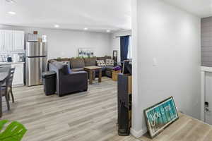 Living room featuring recessed lighting and light wood-style flooring