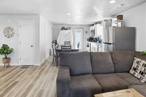 Living area featuring recessed lighting and light wood-style floors