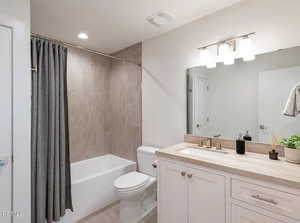 Bathroom featuring shower / bath combination with curtain, vanity, recessed lighting, and light tile patterned flooring