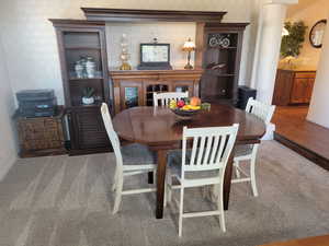 Dining room with baseboards and carpet