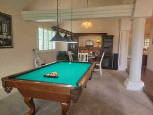 Game room featuring wallpapered walls, ornate columns, pool table, and carpet