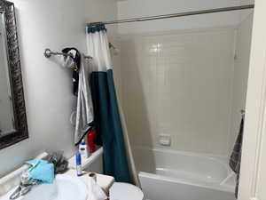 Bathroom with shower / bath combo with shower curtain and vanity