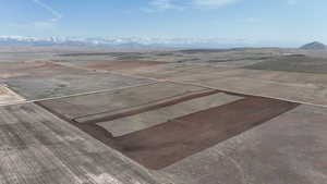 Overview of rural landscape with a mountain backdrop and property parcel outlined