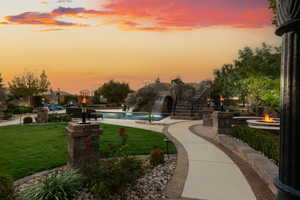 View of home's community with a yard, a pool, a fire pit, and a patio area