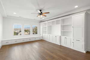 Unfurnished room with dark wood finished floors, a textured ceiling, recessed lighting, ceiling fan, and a raised ceiling
