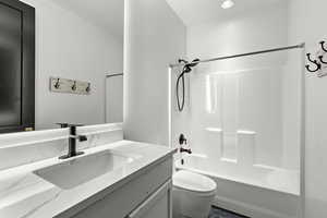 Full bathroom with bathing tub / shower combination, vanity, and recessed lighting