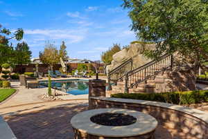 Outdoor pool featuring a fire pit, a patio, and stairs