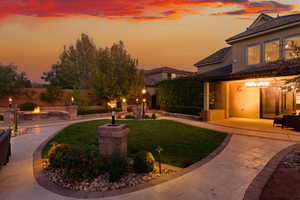 View of front facade featuring a patio, stucco siding, and an outdoor fire pit