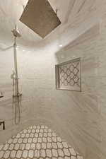 Bathroom featuring a tile shower