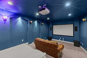 Cinema room with carpet and recessed lighting
