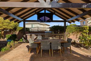 Fenced backyard with outdoor dining space, area for grilling, and a patio