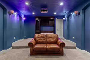 Carpeted cinema featuring recessed lighting and a textured ceiling