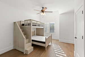Bedroom with wood finished floors and a ceiling fan