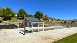 View of swimming pool featuring a patio and a mountain view