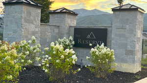 Community / neighborhood sign with a mountain view