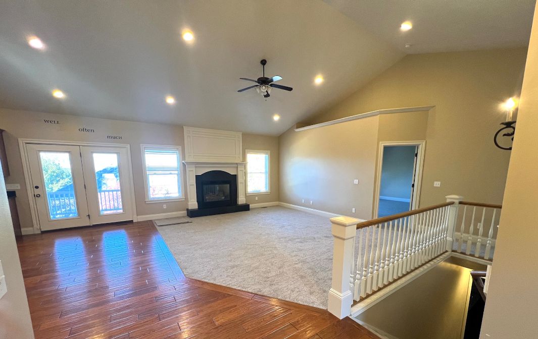 Lots of natural light in open living/dining. Walk out upper deck to backyard and mountain peak views.