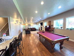 Large family/recreation room with raised ceilings and ample interior and exterior lighting. Radiant heated hard wood flooring.