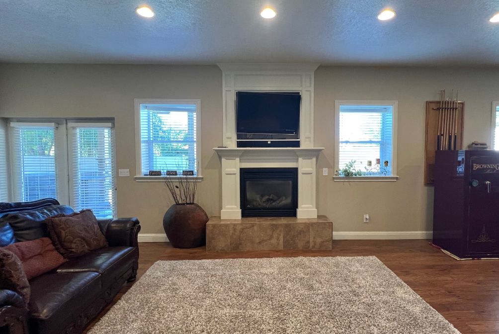 Living/recreation area with gas firplace, raised tile hearth and space for your TV. Walkout to the hot tub with suspended TV.