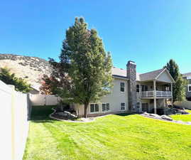 Mountain view from backyard with lush lawn.