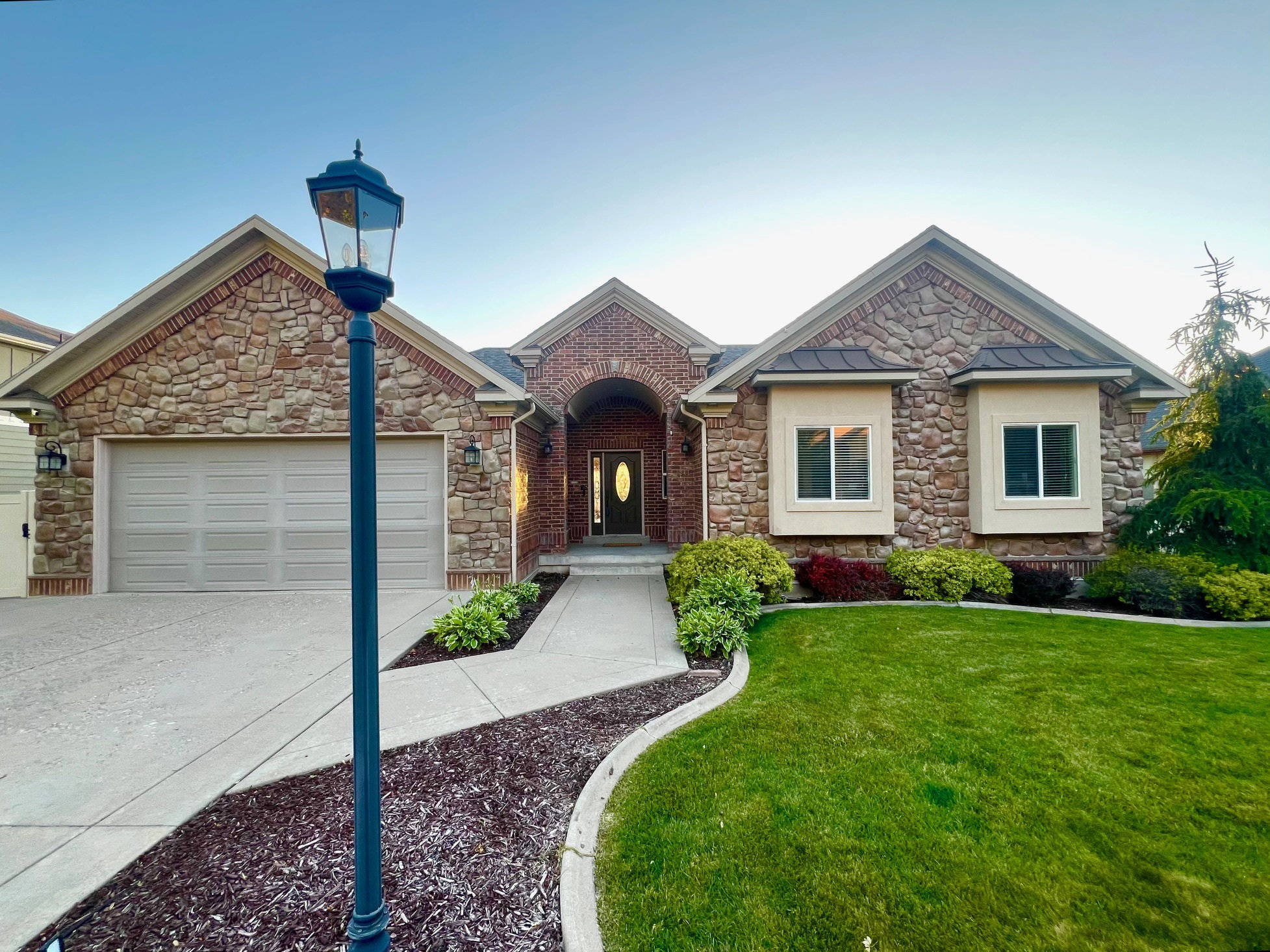 Stone and brick exterior featuring a multi-gabled roofline