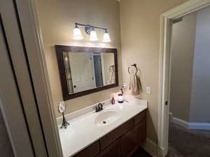 Full guest/hall bath with pocket door to commode and combo tub shower.