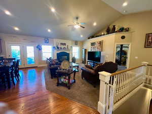 Living area featuring recessed lighting, hardwood floors, a ceiling fan, and high vaulted ceiling.