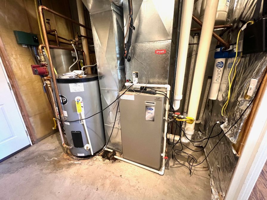 Utility room showing water heater, furnace and boiler to heat floors.