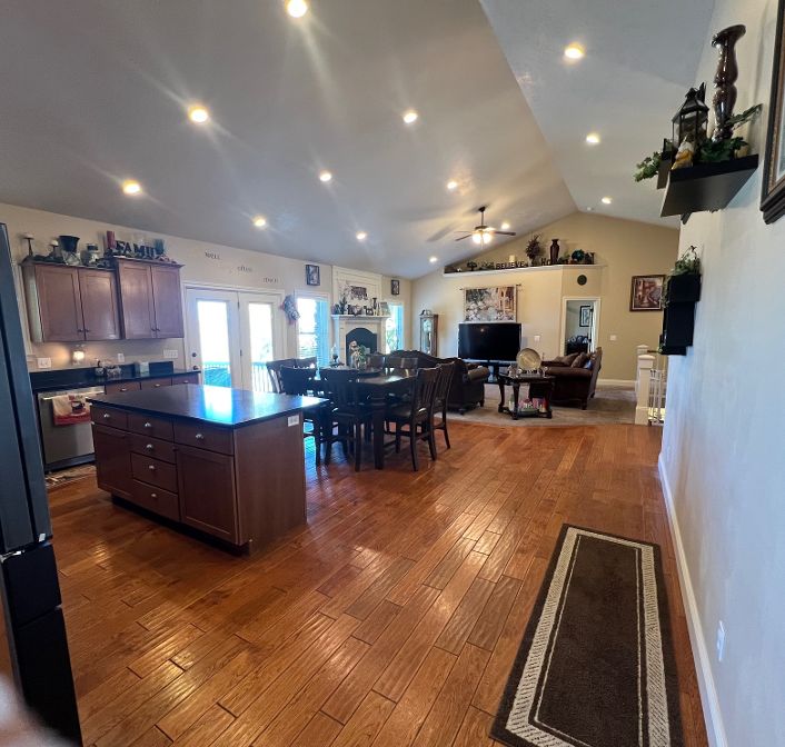 Vaulted ceiling, open floor plan, nice natural light, hardwood floors, and recessed lighting.