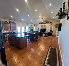 Vaulted ceiling, open floor plan, nice natural light, hardwood floors, and recessed lighting.