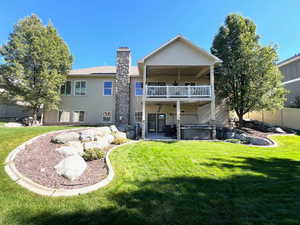 Backyard view showing upstairs deck and downstairs deck with hot tub.