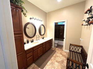 Spacious full bath with double vanity and linen cabinet.