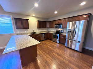 Full second kitchen with granite countertops, stainless appliances and hardwood flooring.